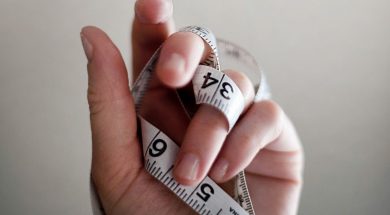Persons-hand-holding-a-tape-measure.jpg