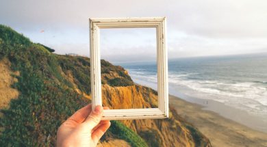 Person-holding-frame-up-to-a-landscape.jpg