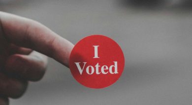 Person-holding-an-I-Voted-sticker.jpg