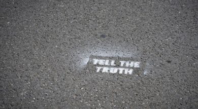 Sign-on-pavement-Tell-the-Truth.jpg